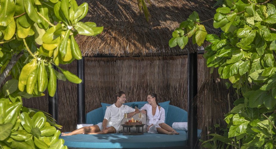 Couple enjoying the private beach cabana of the Two Bedroom Ocean House with Pool at Naladhu Private Islands Maldives